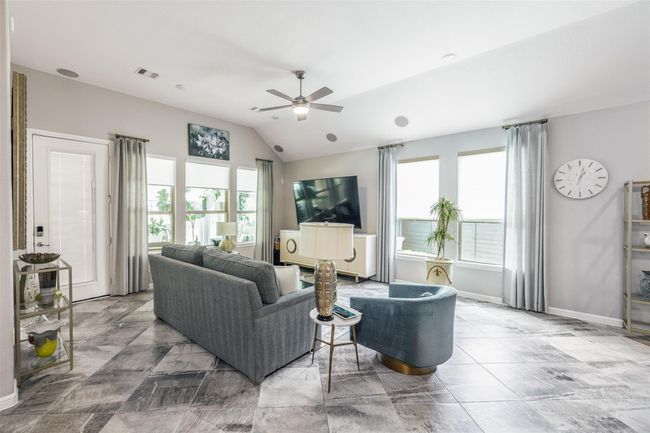 In the living area, new window treatments add a touch of elegance. On the far left, a door leads to the sun room, a recent addition built in 2023, seamlessly integrating indoor and outdoor living. | Image 19