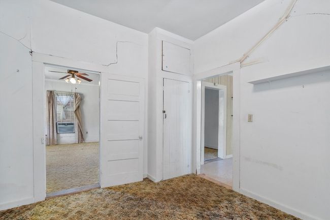 Carpeted empty room featuring ceiling fan | Image 13