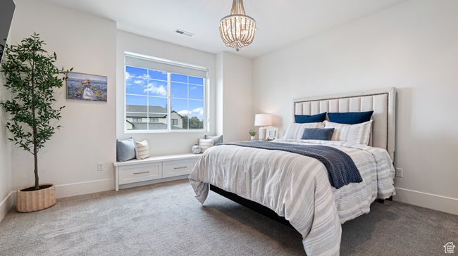 Bedroom with baseboards, visible vents, light colored carpet, and a notable chandelier | Image 47