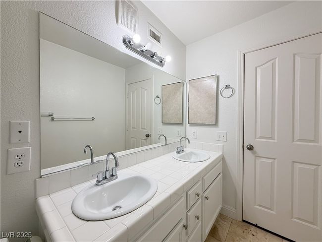 Bathroom with visible vents, a sink, and double vanity | Image 35