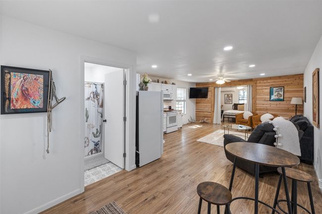 Living area with light wood-type flooring, baseboards, a ceiling fan, and recessed lighting | Image 26
