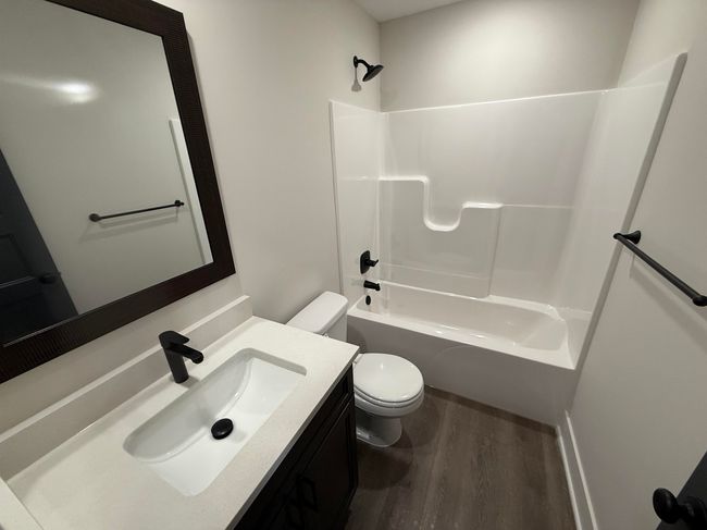 Full bathroom with toilet, wood finished floors, vanity, and bathtub / shower combination | Image 7