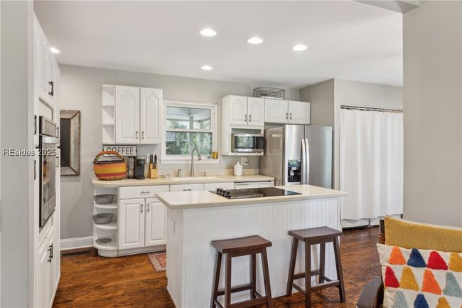 Updated chef's kitchen with stainless steel appliances & ample storage, efficient flow and a window over the sink for a view while prepping and cooking. | Image 21