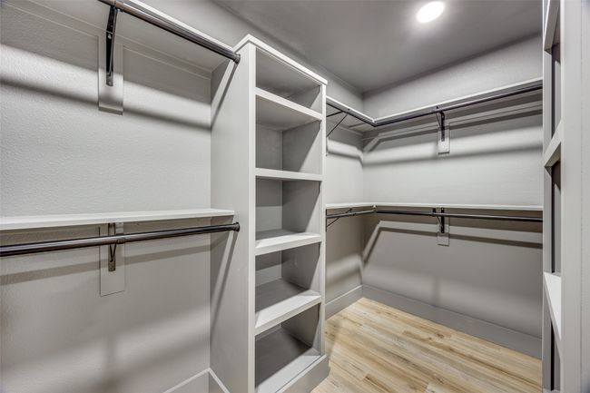 Spacious closet with wood finished floors | Image 24