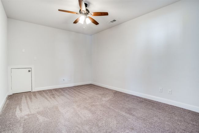 Carpeted empty room featuring ceiling fan and baseboards | Image 18