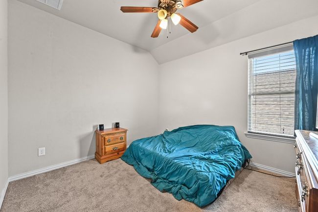 Bedroom with carpet, ceiling fan, and lofted ceiling | Image 23