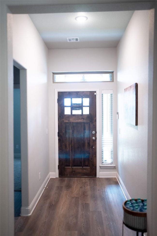 Foyer entrance with dark wood-style floors, visible vents, and baseboards | Image 4