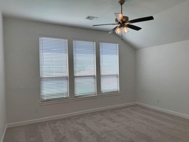 Bonus room with a ceiling fan, visible vents, vaulted ceiling, and carpet | Image 19