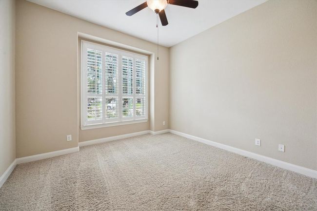 Generous sized Guest En-Suite located downstairs with full bath and plantation shutters | Image 26