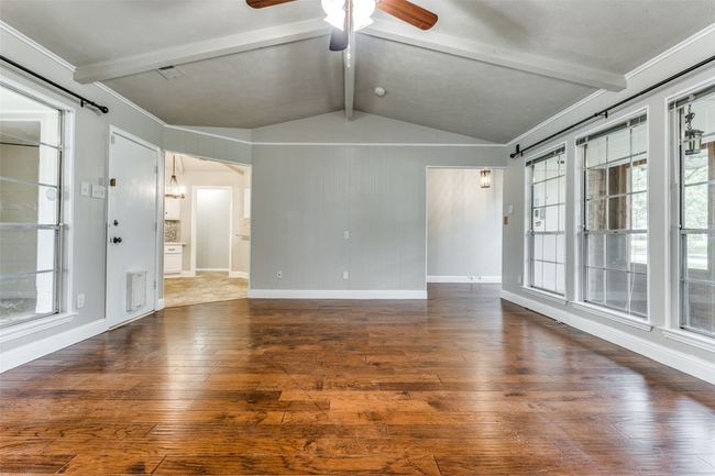 Spare room with wood-type flooring, healthy amount of natural light, and a ceiling fan | Image 6
