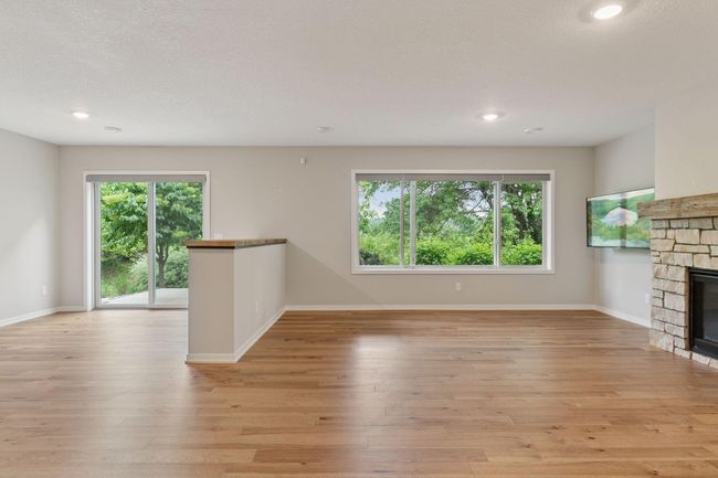 A stone fireplace anchors this space | Image 34