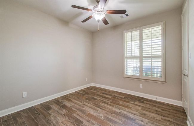 Bedroom 4. Located downstairs has wood tile flooring. | Image 38