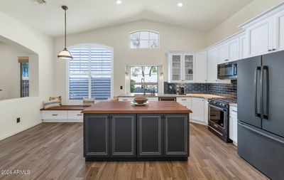 Experience luxury in this remodeled gourmet kitchen, featuring sleek dual-tone cabinetry, high-end stainless steel appliances, and a spacious island perfect for cooking and gathering. A chef’s dream with modern finishes and ample storage. | Image 3