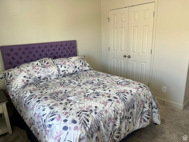 Carpeted bedroom with baseboards and a closet | Image 19