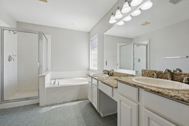 Bathroom featuring a shower stall, a garden tub, double vanity, and tile patterned floors | Image 17