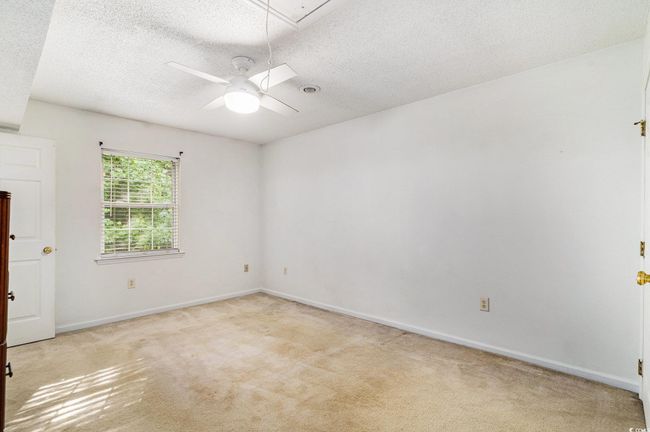 Bedroom with light colored carpet, and attic access | Image 19