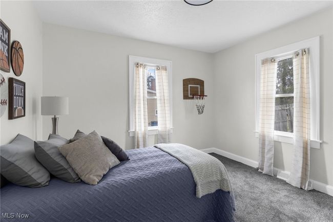 Bedroom with multiple windows, carpet floors, and a textured ceiling | Image 13