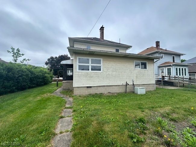 Rear view of house with a yard and central air condition unit | Image 4