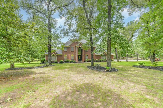 Lush, mature trees elegantly shade the property, enhancing its natural beauty. | Image 44