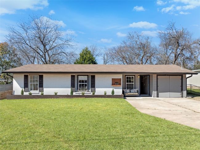 Ranch-style home featuring a garage and a front yard | Image 37