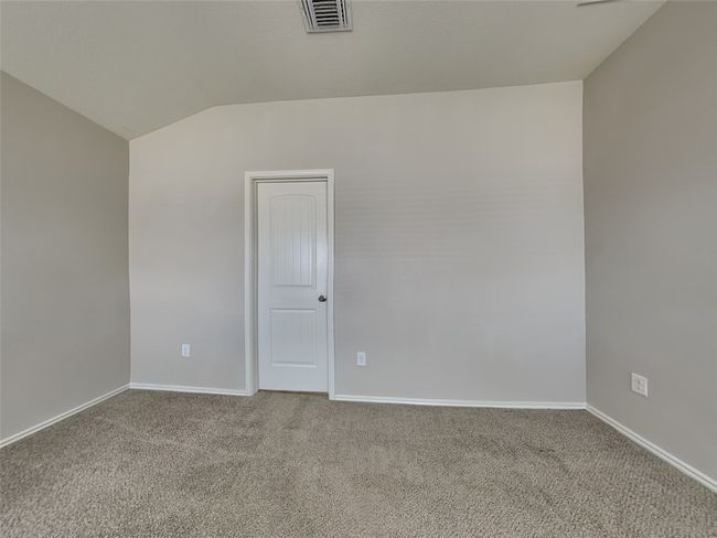 Empty room with lofted ceiling and carpet | Image 8