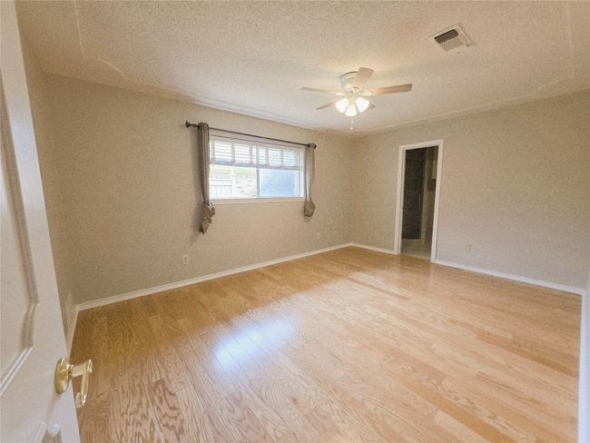 Unfurnished room with light wood finished floors, ceiling fan, and baseboards | Image 23