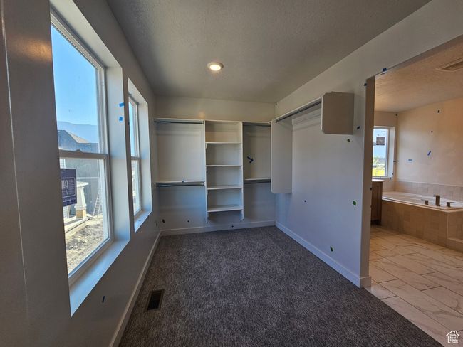 Unfurnished bedroom with a textured ceiling, marble look tile flooring, and recessed lighting | Image 21