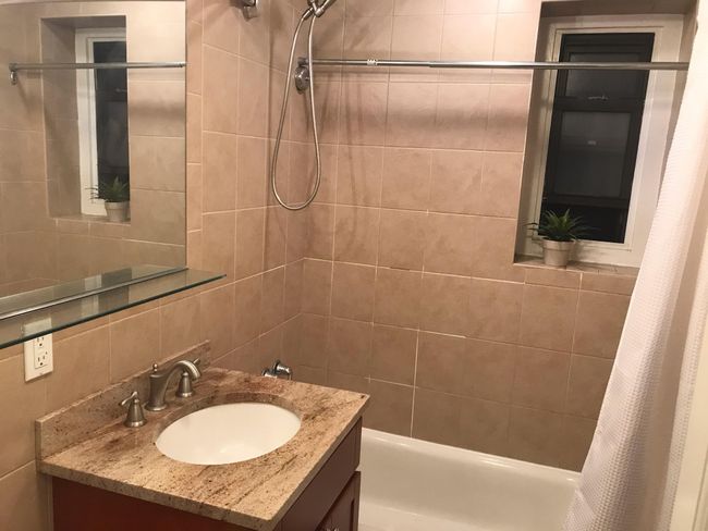 Full bathroom with vanity, shower / tub combo with curtain, tasteful backsplash, and tile walls | Image 7