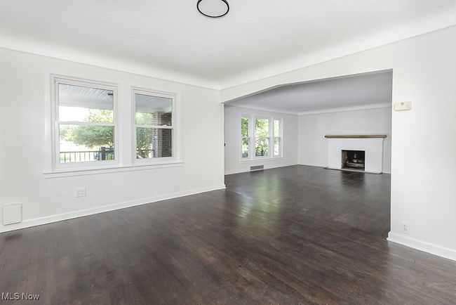 Unfurnished living room featuring dark wood-type flooring | Image 12