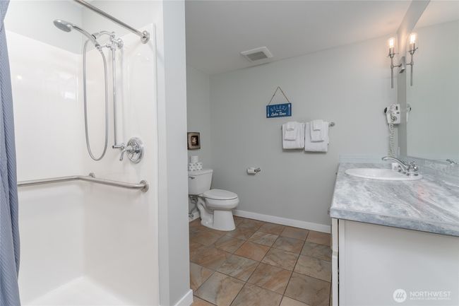 This well thought out walk-in shower is just one more reason this unit has so many advantages as a lucrative vacation rental! | Image 18