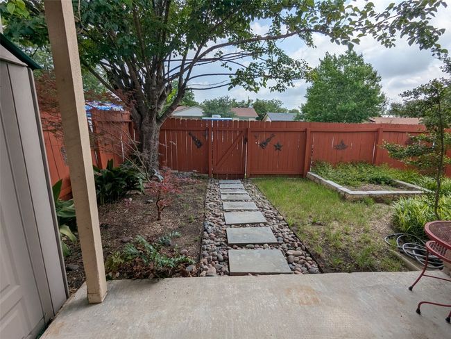Fenced backyard with a patio area | Image 4