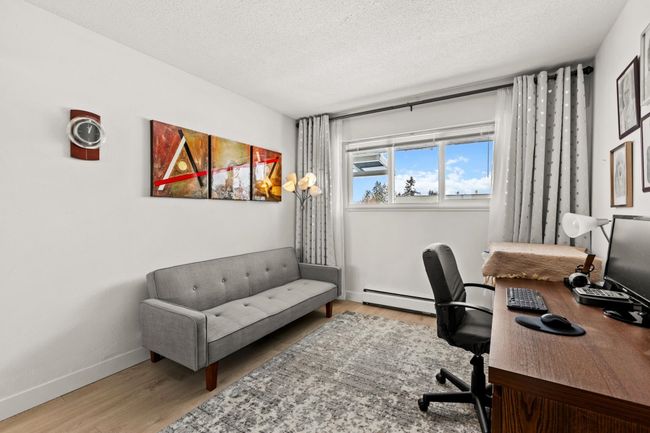 Office with baseboards, baseboard heating, wood finished floors, and a textured ceiling | Image 17