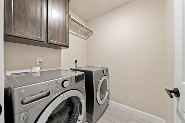 Laundry room with built in cabinets | Image 25