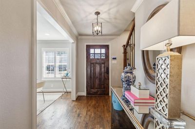 Foyer entrance featuring ornamental molding, a notable chandelier, and dark hardwood / wood-style floors | Image 3