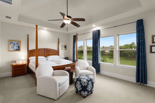 Primary Bedroom featuring a raised ceiling and sitting area. | Image 16