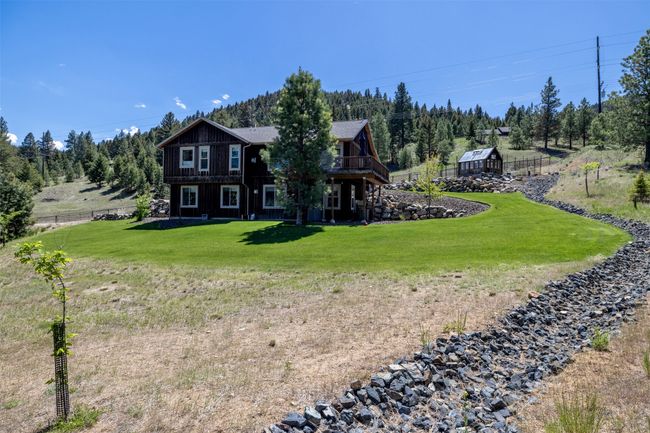 Rear view of house featuring an outdoor structure and a deck | Image 52