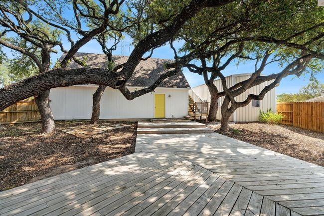 View of front of home with a deck and fence | Image 27