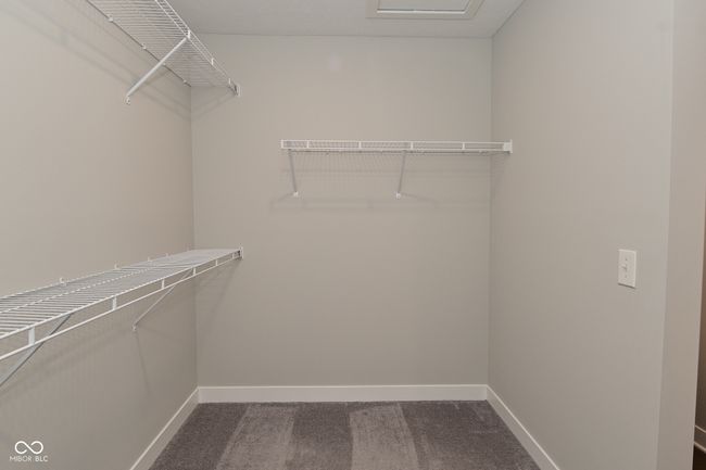walk in closet with dark carpet | Image 46
