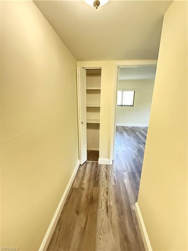 Corridor featuring baseboards and dark wood-style flooring | Image 11