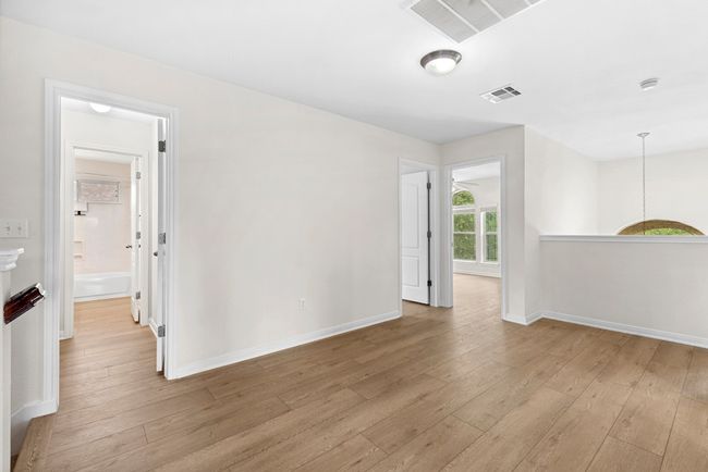 Empty room featuring light wood-style flooring and a smoke detector | Image 23