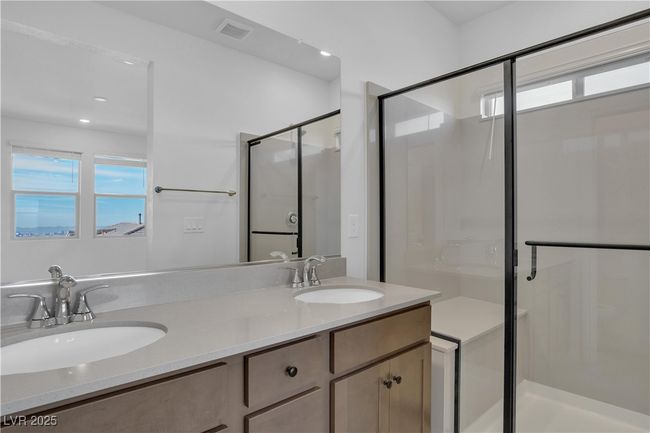 Bathroom with a wealth of natural light, visible vents, a stall shower, and a sink | Image 19