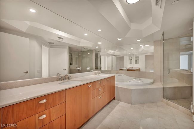 Bathroom with a bath, visible vents, a stall shower, and a sink | Image 38