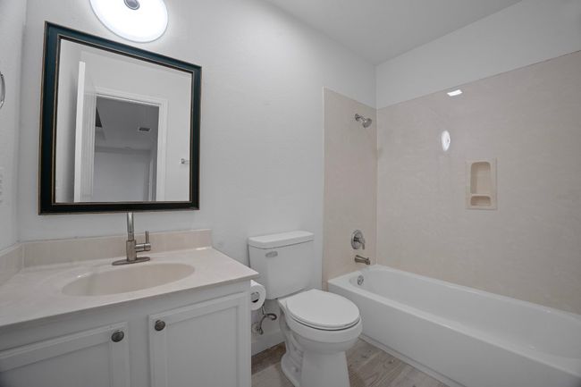 Bathroom with vanity, shower / washtub combination, and wood finished floors | Image 27