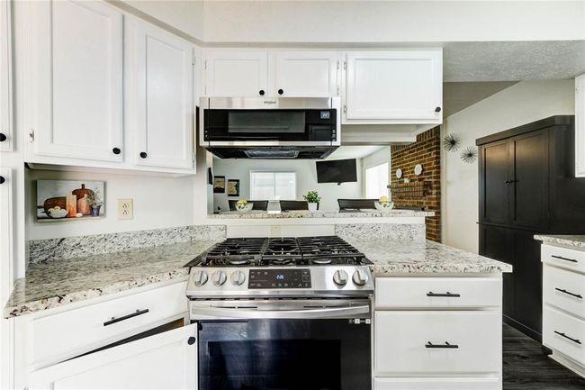 This kitchen was made for hosting—featuring granite countertops, freshly painted cabinets, and a gas stove perfect for home-cooked meal | Image 21