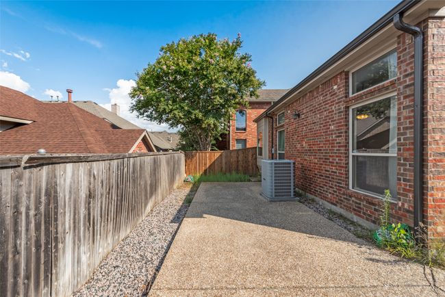 Fenced backyard with a patio area | Image 19