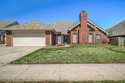 View of front of home with a garage and a front lawn | Image 1