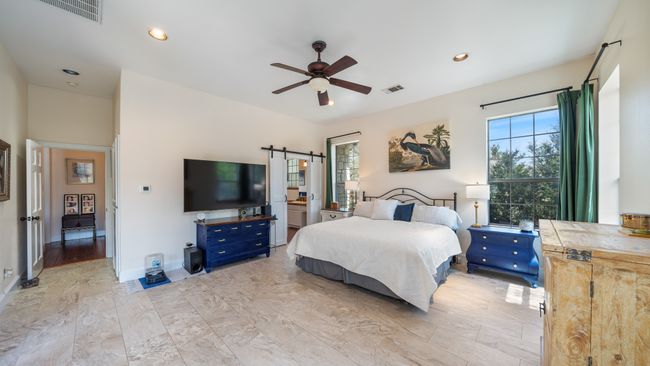 Bedroom with multiple windows, a barn door, and visible vents | Image 18