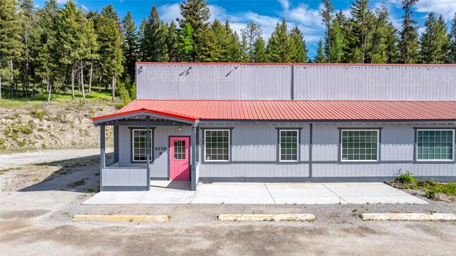 View of front of home featuring uncovered parking and metal roof | Image 102