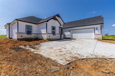 Modern farmhouse style home featuring a garage | Image 2