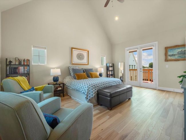 Bedroom featuring access to outside, high vaulted ceiling, wood finished floors, recessed lighting, and baseboards | Image 8